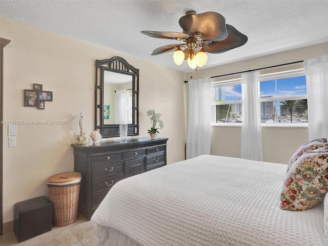 bedroom featuring a textured ceiling and ceiling fan