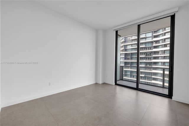 unfurnished room with floor to ceiling windows