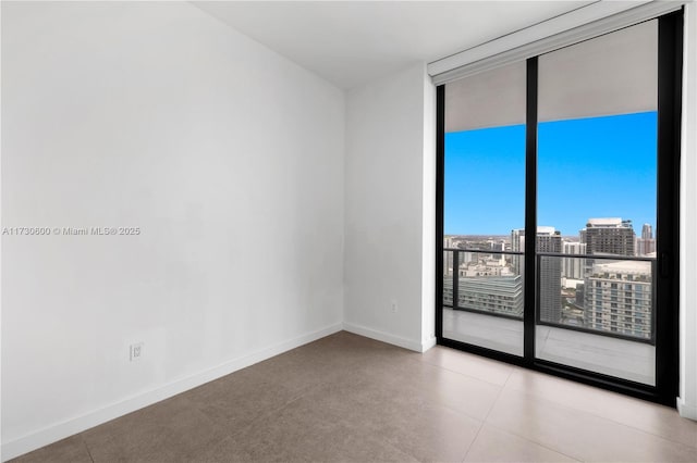 unfurnished room featuring a wall of windows