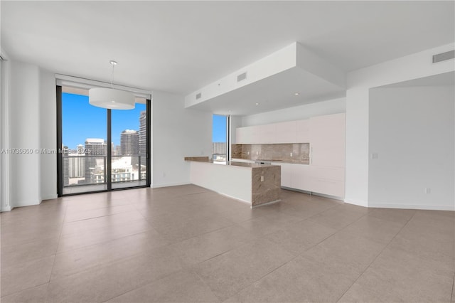 unfurnished living room featuring expansive windows