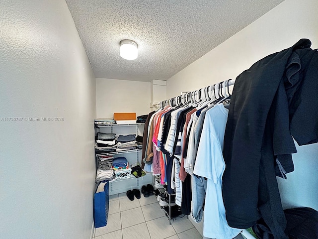 spacious closet with light tile patterned floors