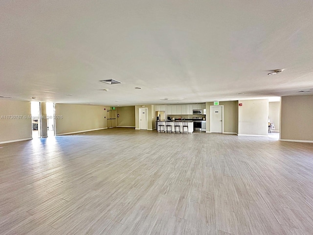 unfurnished living room with light wood-type flooring