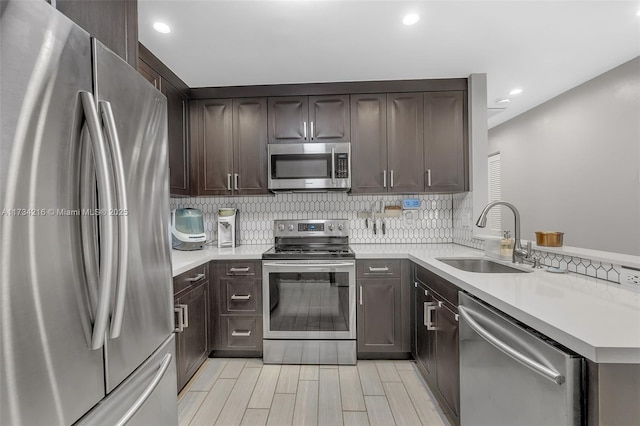 kitchen with stainless steel appliances, sink, and dark brown cabinets