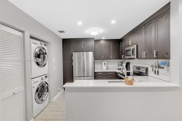 washroom with stacked washer / dryer