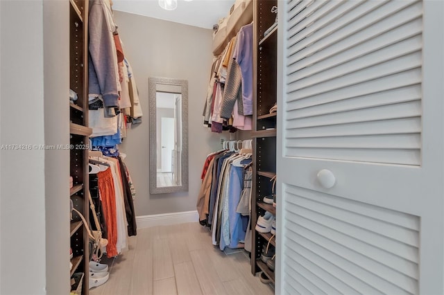 spacious closet featuring light wood-type flooring