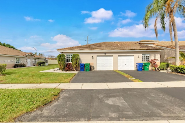 view of front of property featuring a garage and a front yard