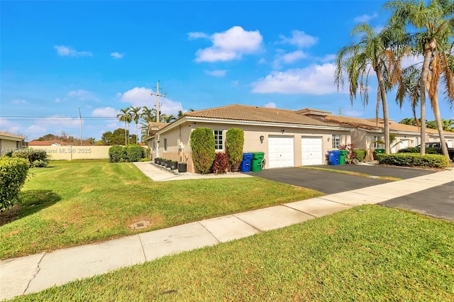 view of front of property with a garage and a front yard