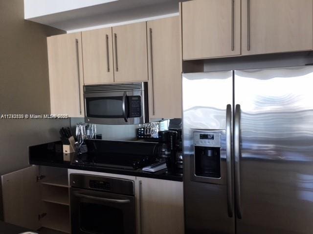 kitchen with appliances with stainless steel finishes and light brown cabinets