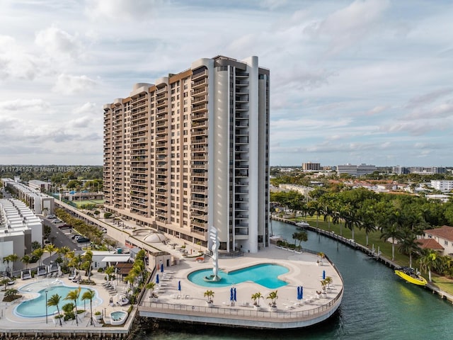 view of building exterior featuring a city view and a water view