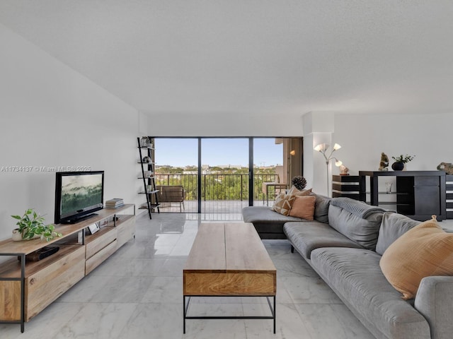 living room featuring marble finish floor and an inviting chandelier