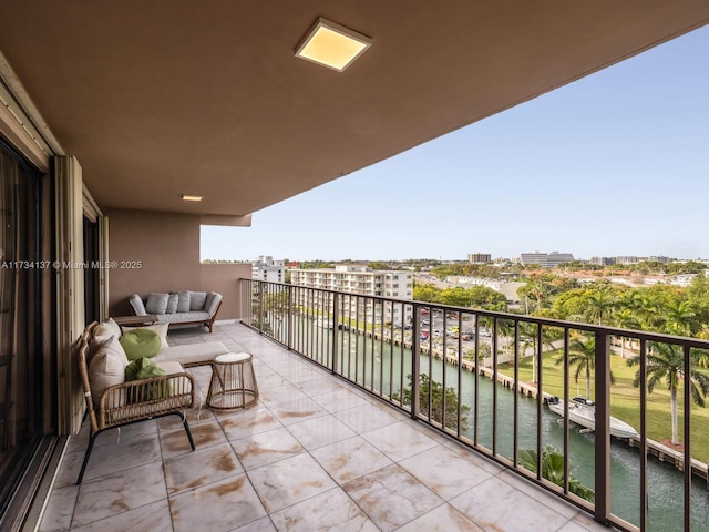 balcony featuring a water view and a city view