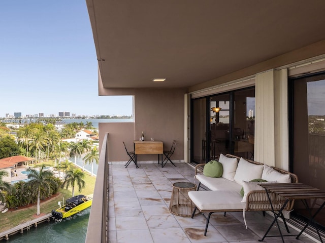 balcony featuring a water view, a city view, and outdoor lounge area