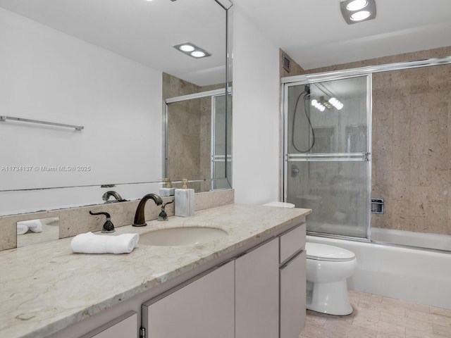 bathroom featuring vanity, toilet, and enclosed tub / shower combo