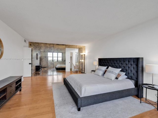 bedroom featuring visible vents and light wood-type flooring