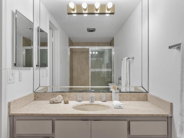 full bath featuring a shower stall and vanity