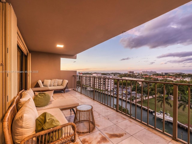 balcony featuring a water view and a view of city