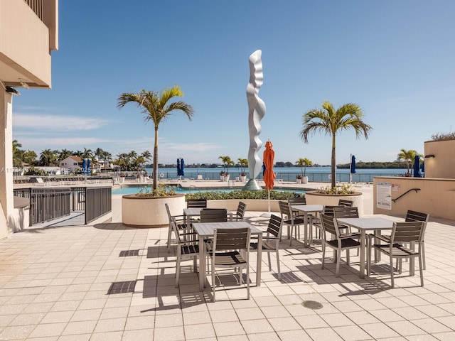 view of patio featuring outdoor dining area and a water view