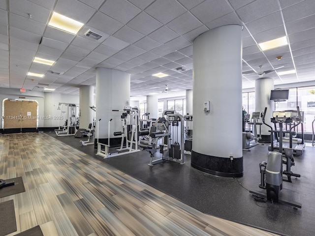 exercise room with visible vents and a paneled ceiling