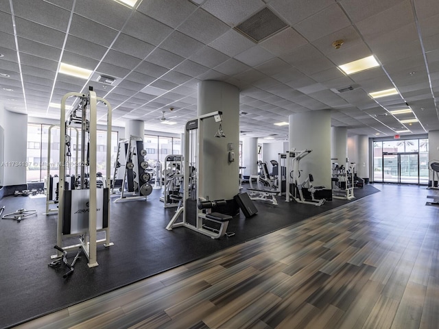 exercise room featuring a paneled ceiling and visible vents