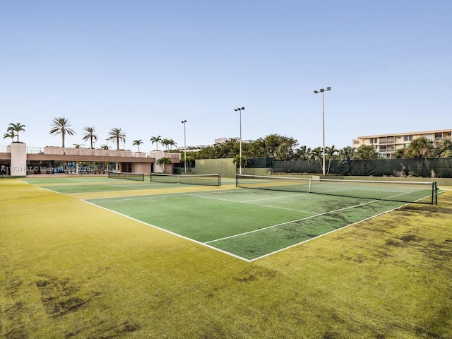 view of tennis court with fence