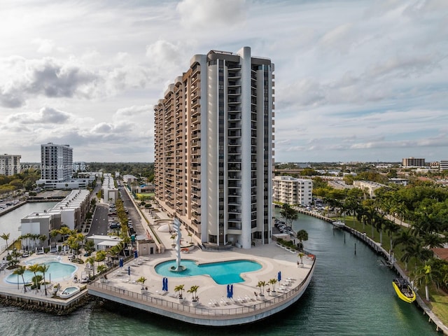 view of swimming pool featuring a view of city and a water view