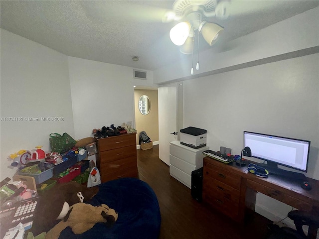 bedroom with dark hardwood / wood-style flooring, a textured ceiling, and ceiling fan