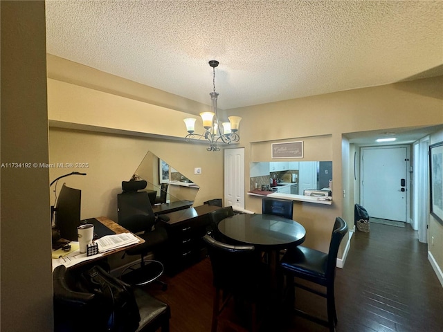 dining area with an inviting chandelier, dark hardwood / wood-style flooring, and a textured ceiling