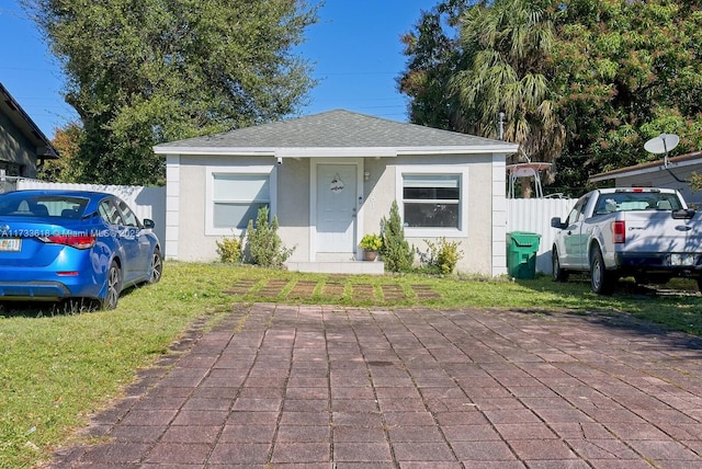 bungalow-style home with a front yard