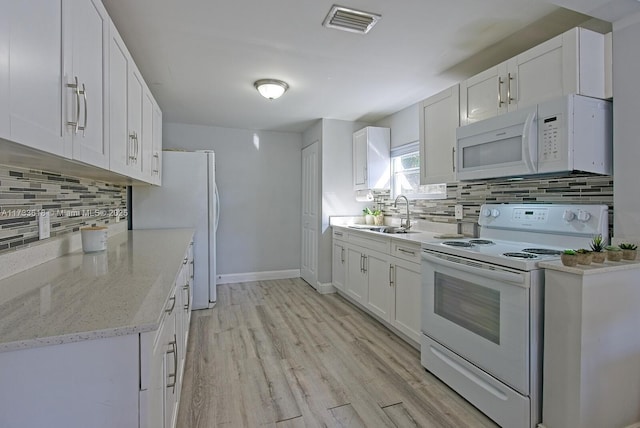 kitchen featuring sink, white cabinetry, light wood-type flooring, white appliances, and decorative backsplash