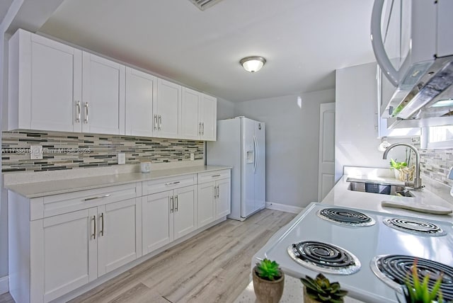 kitchen featuring sink, light wood-type flooring, white appliances, decorative backsplash, and white cabinets