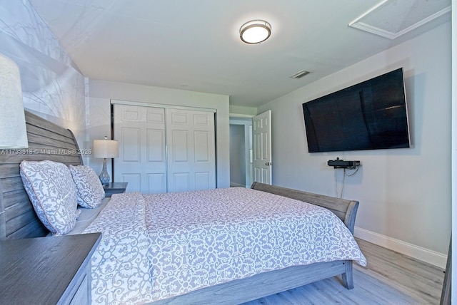 bedroom featuring wood-type flooring and a closet