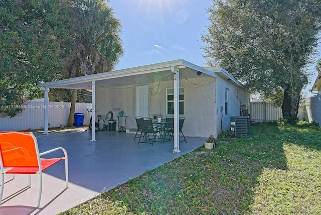 exterior space with a lawn and central air condition unit