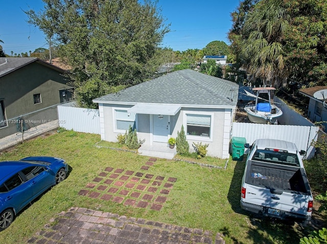 bungalow-style home with a front yard