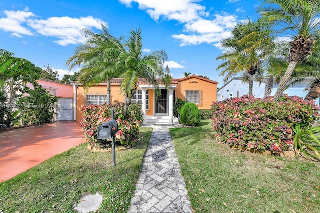 mediterranean / spanish-style home with a front yard