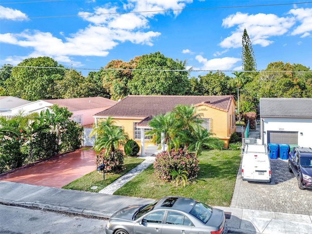 mediterranean / spanish home with a garage and a front yard