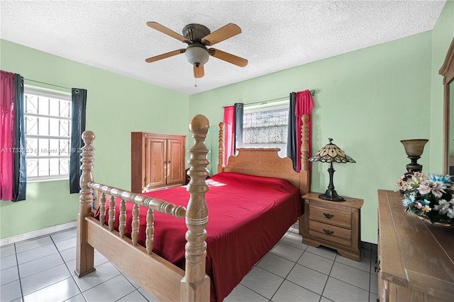 bedroom featuring light tile patterned flooring, ceiling fan, and multiple windows