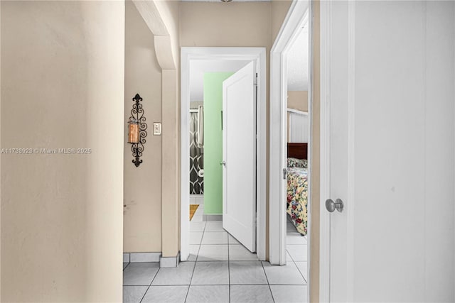 hall featuring light tile patterned flooring