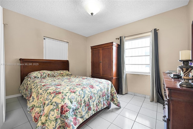 tiled bedroom with a textured ceiling