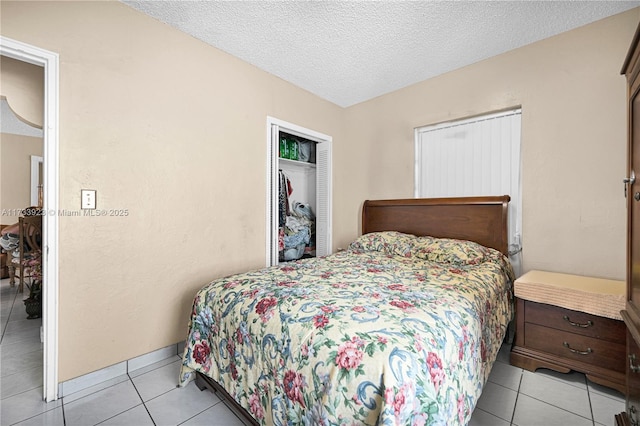 tiled bedroom featuring a textured ceiling and a closet