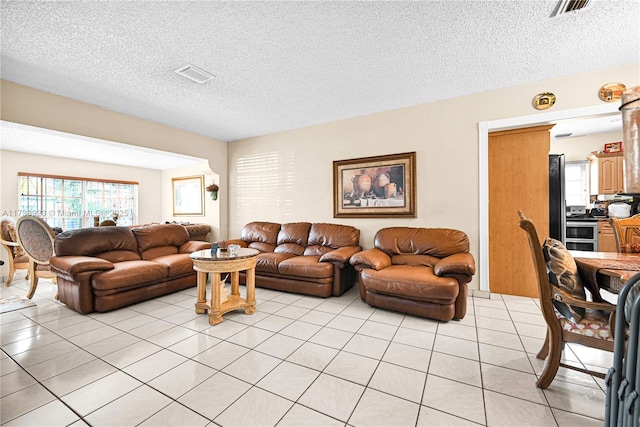 tiled living room with a textured ceiling