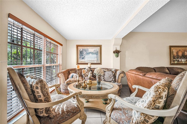 dining space featuring tile patterned floors and a textured ceiling