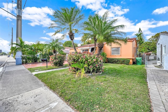 mediterranean / spanish-style home featuring a front yard