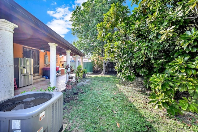 view of yard featuring central AC and a patio area