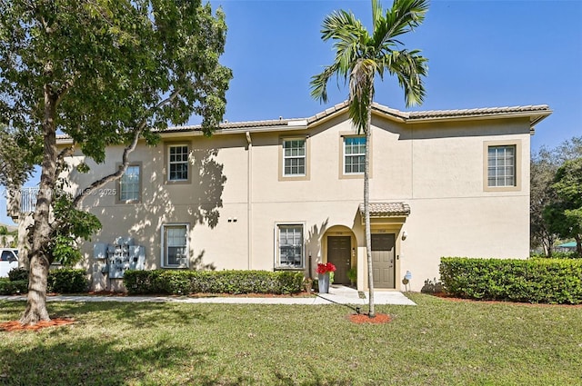 mediterranean / spanish-style home featuring a front lawn