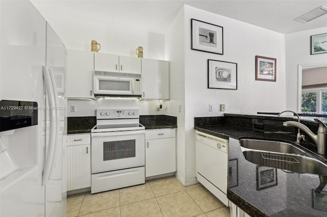 kitchen with white cabinetry, sink, and white appliances