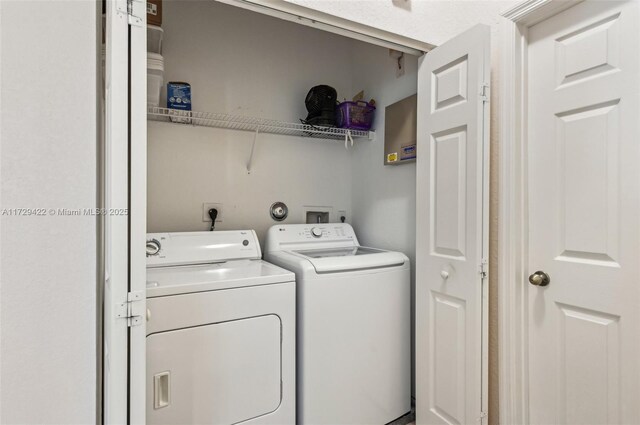 clothes washing area with washer and dryer