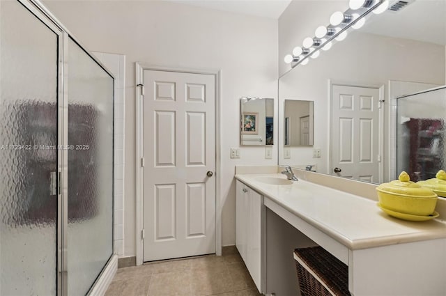 bathroom featuring vanity, tile patterned floors, and walk in shower