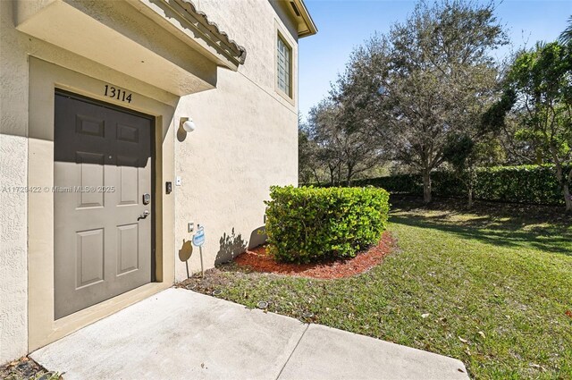 property entrance with a yard