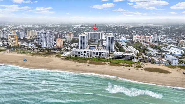 bird's eye view featuring a view of the beach and a water view