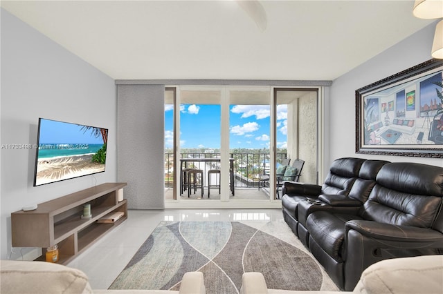 tiled living room featuring a wall of windows